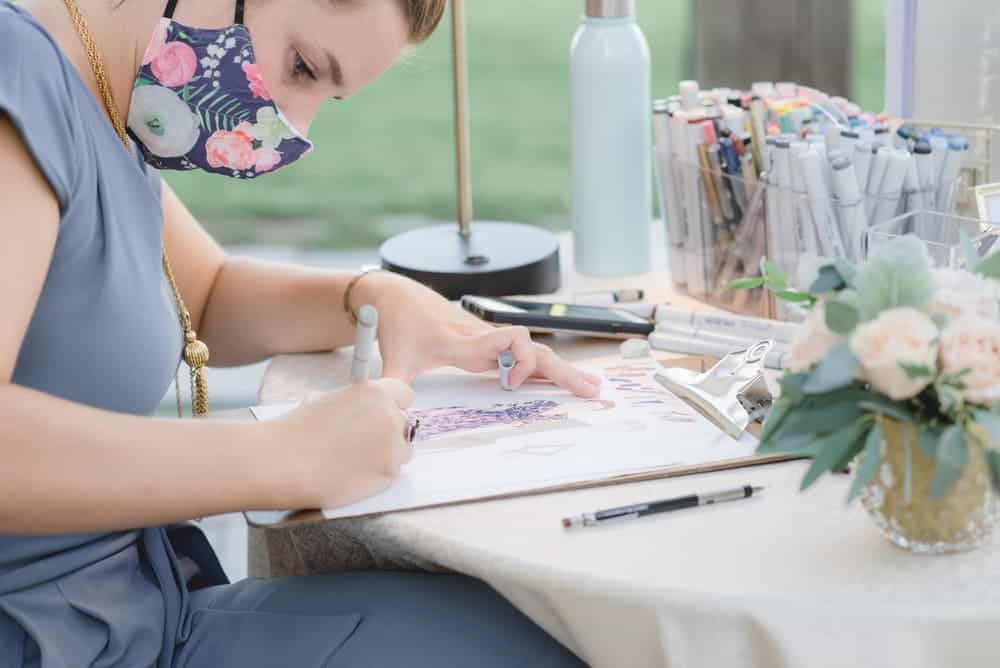 girl drawing picture at wedding