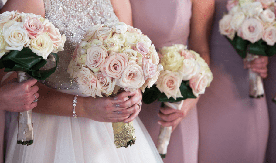 bridesmaids holding bouquet of flowers